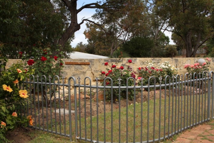 Memorial rose garden with a fence around it.